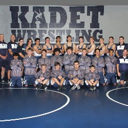 The AAHS wrestling team poses in their gym.